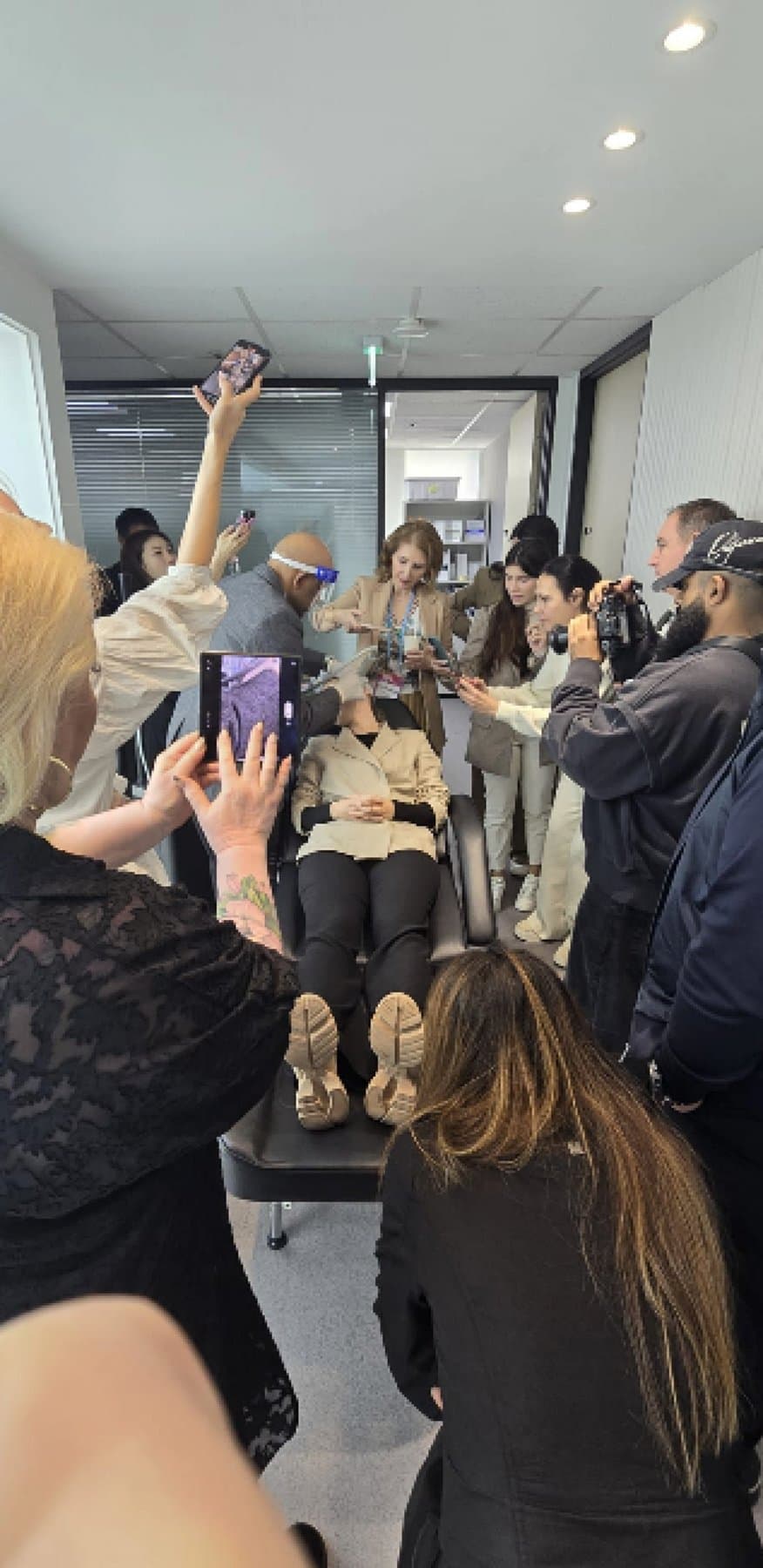 Practitioners gathered around a live demonstration at a Regenesis workshop